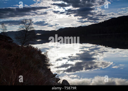 Looking across Loch Beinn a'Mheadhoin in evening light to ancient Caledonian pine forest Glen Affric National Nature Reserve Highland Region Scotland  Stock Photo