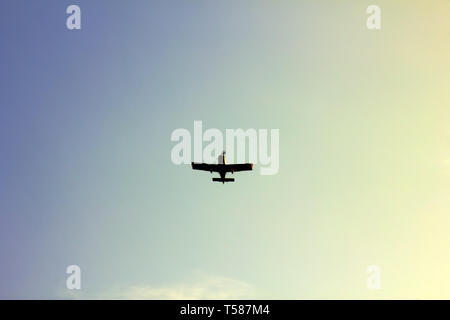 Kind of sports aircraft single screw with massive wings and changing geometry of wing in air. Silhouette of plane, view from below Stock Photo