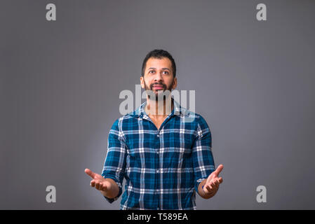A young black man standing and feeling surprised Stock Photo