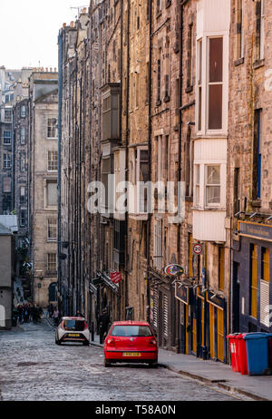 View down Niddry Street with tall tenement buildings and cobbled road, off Royal Mile, Edinburgh, Scotland, UK Stock Photo