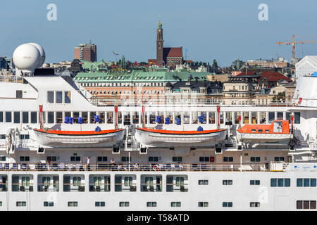 The Saga Sapphire cruise ship frames a view of Engelbrektskyrkan (the Engelbrekt Church) and the Grand Hotel in Stockholm Stock Photo