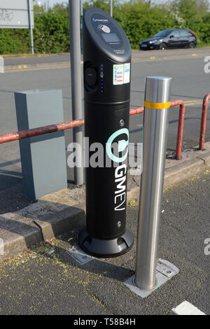 Gmev electric vehicle charging point and stainless steel bollard in car park in bury town centre in lancashire uk Stock Photo