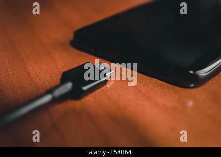 close up of black Smartphone charging Stock Photo