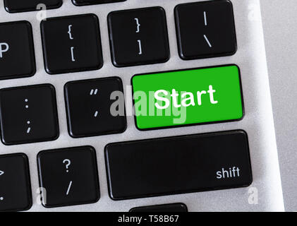 Green button with word Start on computer keyboard. Stock Photo