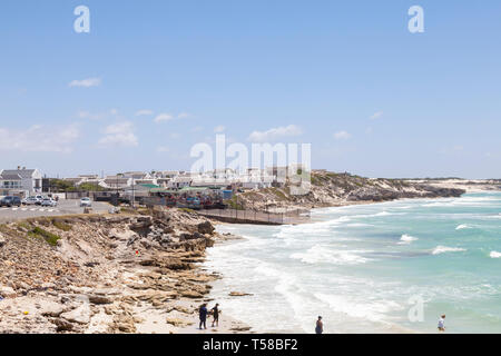 The quaint fishing village of Arniston, Agulhas, Western Cape, South Africa, with whitewashed historical cottages. Waterfront and beach view, people i Stock Photo