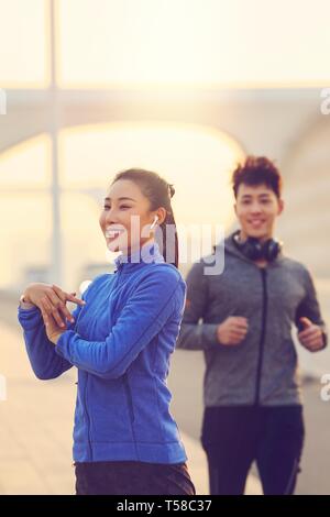 Young men and women outdoor exercise Stock Photo
