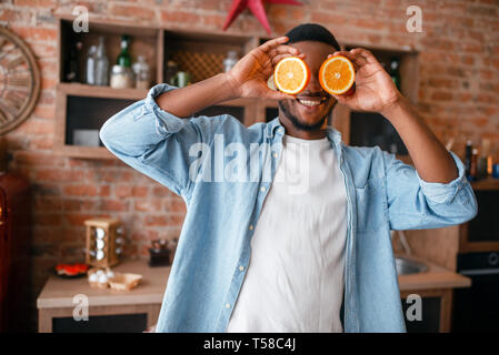 Black man having fun while cooking on the kitchen Stock Photo
