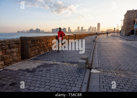 Jaffa Old City, Tel Aviv, Israel - April 1, 2019: Beautiful view of the side walk on the ocean coast during a sunny sunrise. Stock Photo