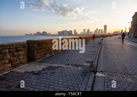 Jaffa Old City, Tel Aviv, Israel - April 1, 2019: Beautiful view of the side walk on the ocean coast during a sunny sunrise. Stock Photo