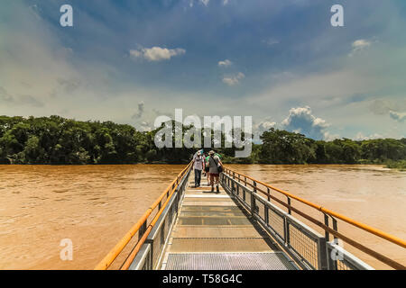 Misiones Province, Argentina - Jan 2015: The metal walkway from Pueto Iguazu towards the waterfalls at Iquazu Falls Stock Photo