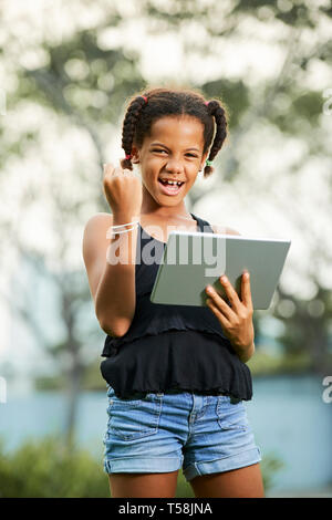Successful teen girl using tablet Stock Photo