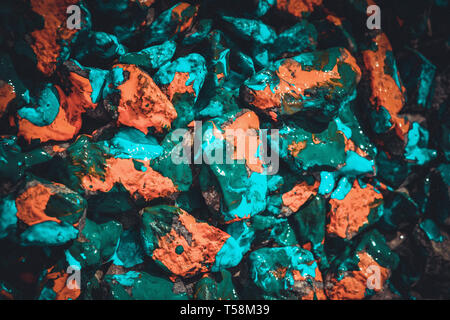 Bright abstract background stones covered with orange, blue and green neon colors Stock Photo