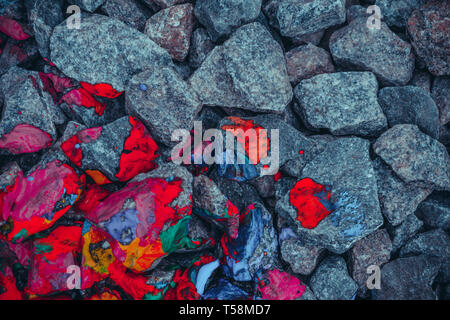 background gray stones and rocks painted in mottled red, view from above Stock Photo