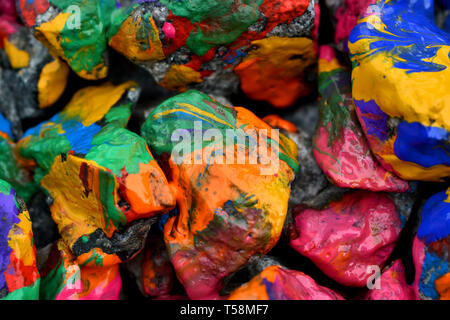 stones with colorful paint. Abstract background colored stones randomly in different colors Stock Photo