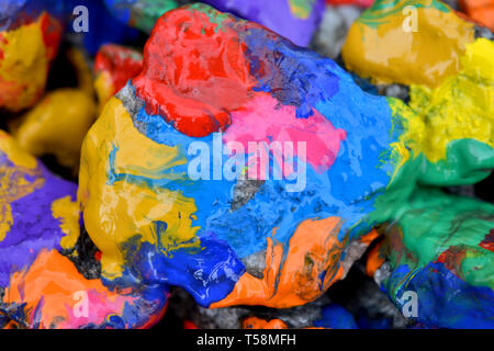 stones with colorful paint. Abstract background colored stones randomly in different colors Stock Photo