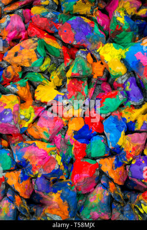 abstract background colored stones. Stones painted with multicolored paint Stock Photo