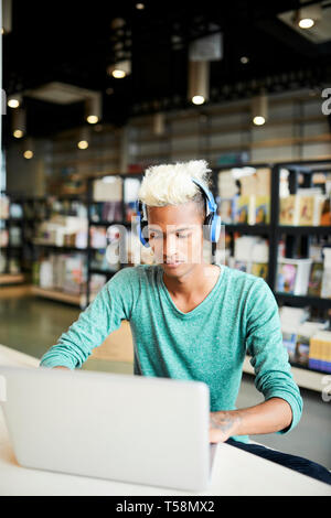 Serious university student using laptop Stock Photo