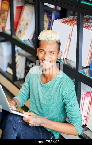 Excited university student guy with laptop Stock Photo