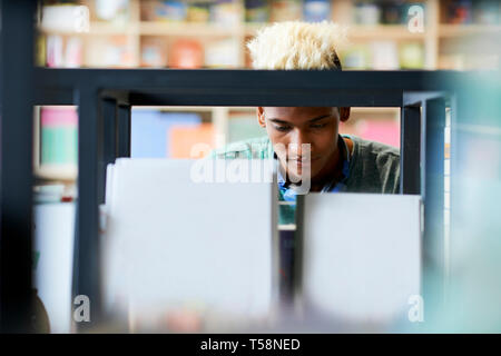 Black student with blond hair in library Stock Photo