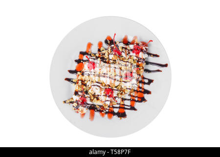 Dessert of ice cream vanilla, whipped cream, cherry, banana, chocolate and berry topping, split, white isolated background in glass. Dish for the menu Stock Photo