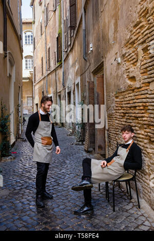 Restaurant waiters having a break in the Jewish Quarter, Rome, Italy Stock Photo