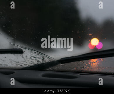 Stormy drive in car with wet windshield wipers on dashboard Stock Photo