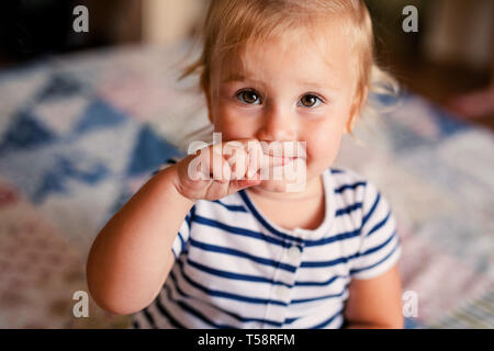 Newborn baby boy in bed. Cute toddler girl playing with her newborn baby brother. Stock Photo