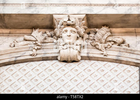 An 18th century sculpted woman's face looks out from the wall of the Hall of State in Stockholm's Royal Palace. Stock Photo