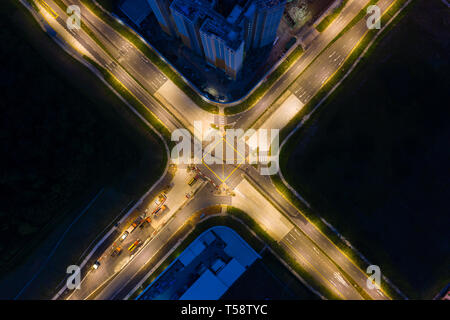 Aerial view of a lighted up cross junction road in the night Stock Photo
