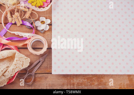 Tools and materials for creativity scattered on the table. Scrapbooking, creative mess. Copy space for text. Top view. Stock Photo
