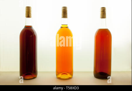 Three bottles of tawny wine with different tones. Wine colors concept Stock Photo