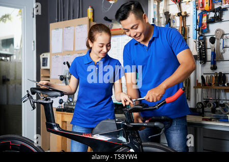 Couple of mechanics working in team Stock Photo
