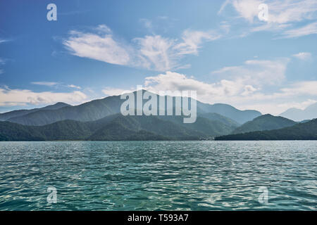 Beautiful sunrise scenics of Sun Moon Lake with the surrounding mountains are the highlight at this sprawling lake at Yuchi, Nantou in Taiwan. Stock Photo