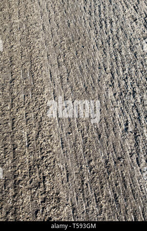 Road surface after a cold planer or milling machine has stripped off the tarmac, prior to resurfacing with fresh tarmac or asphalt Stock Photo