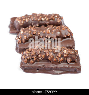 Small chocolate covered cakes with crushed nuts isolated on white background Stock Photo