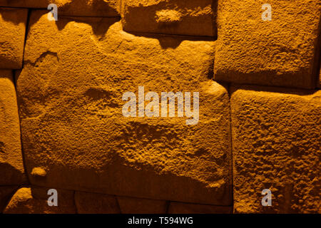 View to Twelve-angled stone aka Hatun Rumiyoc as a part of a wall of the palace of the Archbishop of Cuzco in Peru Stock Photo