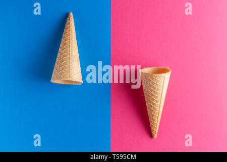 Ice cream cornet on blue and pink background with place for text, minimal concept Stock Photo