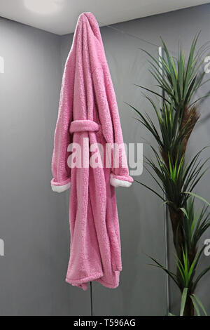 Pink Robe Hanging Soft pink bath robe hanging on the glass inside spa interior Stock ...