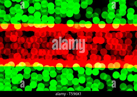 Unfocused abstract green and red bokeh on black background. defocused and blurred many round light. Stock Photo