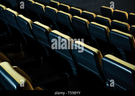 rows of comfortable plastic empty seats in cinema hall Stock Photo