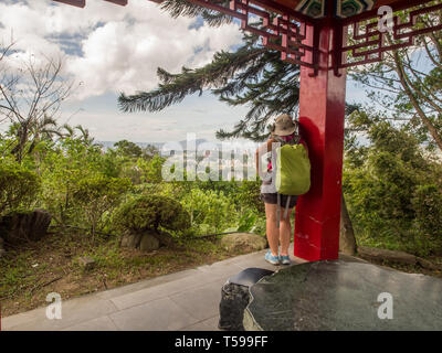 Maokong, Taiwan - October 19, 2016: Women with racksack looking for Taipei City from the park of  the Chih Nan Temple on the hills of Maokong  in Taiw Stock Photo