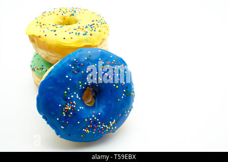 Blue doughnut with sprinkles sitting on a stack of donuts Stock Photo