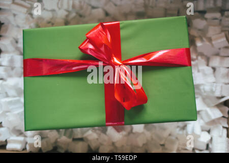 Parcel with gift box inside. Open parcel with present inside Stock Photo