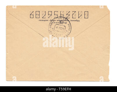 Old worn envelope with USSR meter stamp, worn and yellowed paper, closed, isolated on white background. Russian inscription: "Attention! Sample of fil Stock Photo