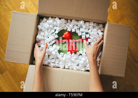 Woman hands opening a parcel contains a gift Stock Photo
