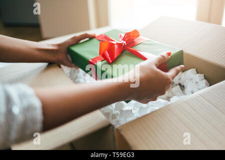 Woman hands opening a parcel contains a gift Stock Photo