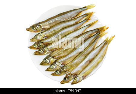 Smoked capelin on a white plate close-up isolated Stock Photo
