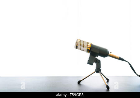 low angle view of microphone on table against bright white background Stock Photo