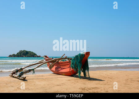 Traditional fishing boat on Sri Lanka ocean beach Stock Photo