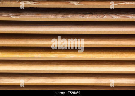 Sample parquet boards in hardware store, in home improvement warehouse exterior. Picture of different colors wooden laminate flooring in shop. Concept Stock Photo